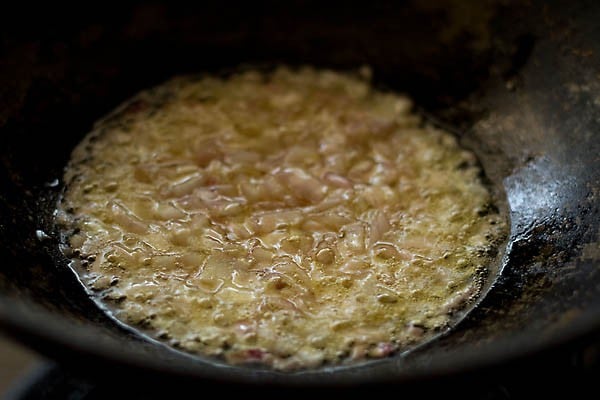 sauteing onions in oil in a pan