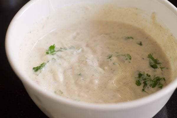 mixing onion raita