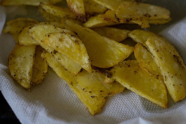 frying potatoes to make schezwan chilli potatoes recipe
