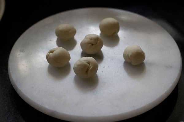 dough balls made and kept on a white marble board