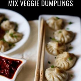 veg momos arranged on a white rectangular long tray with bamboo chopsticks by the side with text layover.