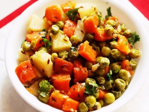 aloo gajar matar served in a white bowl.dry gajar aloo matar recipe