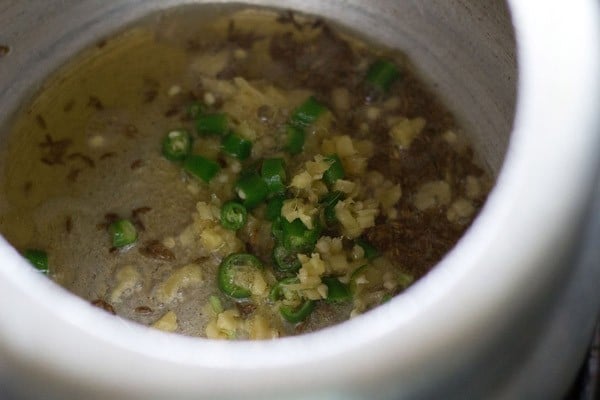 finely chopped ginger and finely chopped green chilies added to the pressure cooker. 