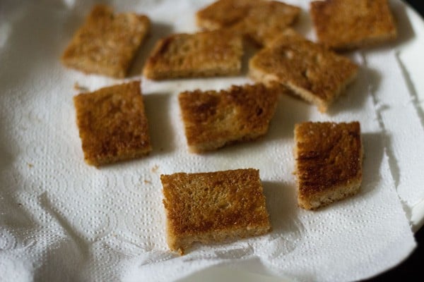 draining fried bread slices on paper towels for making shahi tukda recipe