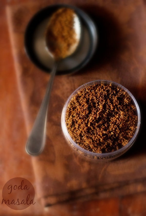 overhead shot of an open spice jar filled with freshly made Maharashtrian goda masala.