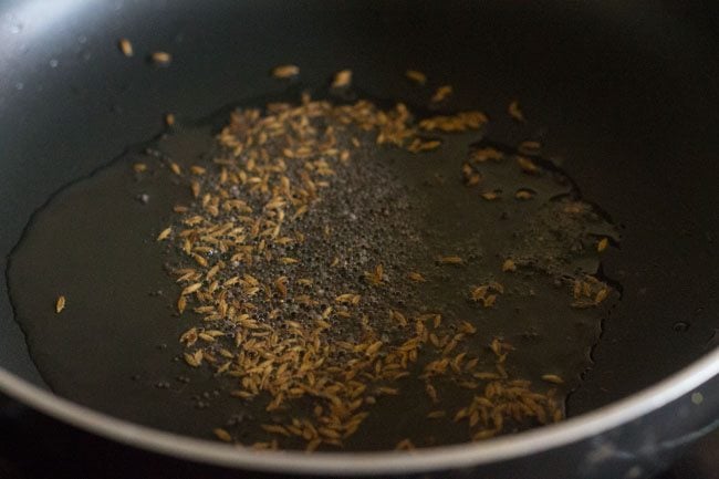 sautéing cumin seeds in hot oil. 