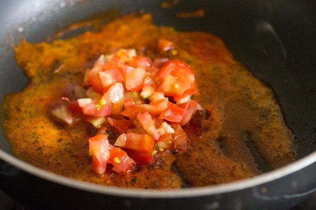 chopped tomato added to the pan. 