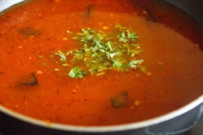 Add chopped coriander leaves to katachi amti. 