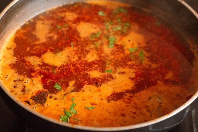 cooked katachi amti garnished with coriander leaves. 