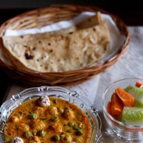 matar makhana curry served with a side of roti and vegetable salad.