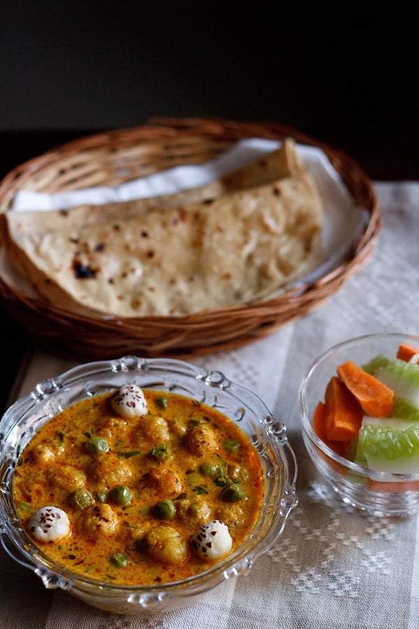 matar makhana curry served with a side of roti and vegetable salad.