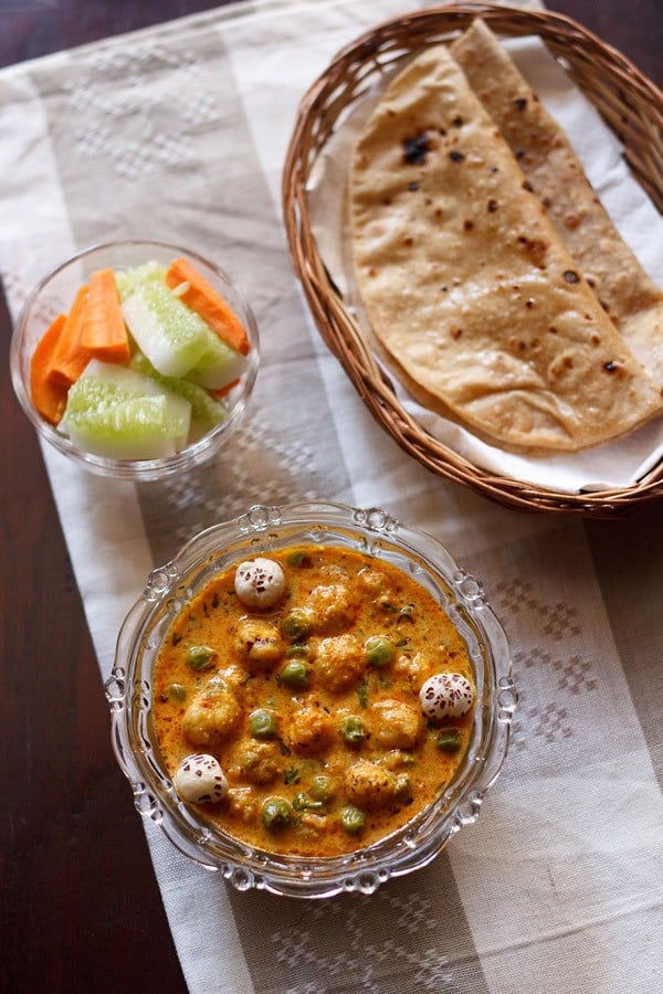 khoya matar makhana curry served with a side of roti and vegetable salad