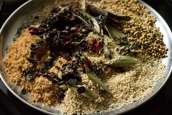 roasted seeds and spices all on a plate waiting to be ground into masala.