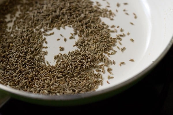 roasting cumin seeds to make goda masala recipe.