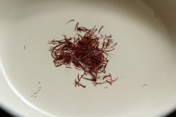 roasting saffron till it changes to a darker shade. 