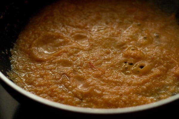 prepared paste added to hot oil with spices in a pan to make matki amti. 