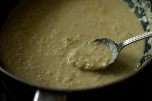 spoon showing lightly curdled consistency of rabdi