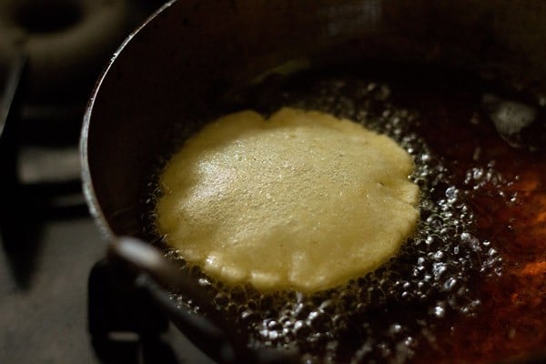 frying rice puri in hot oil. 