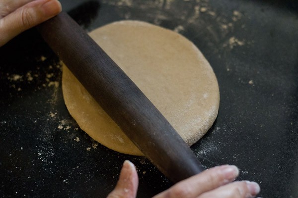 rolling dough ball into a thick chapatti for making calzone pocket. 