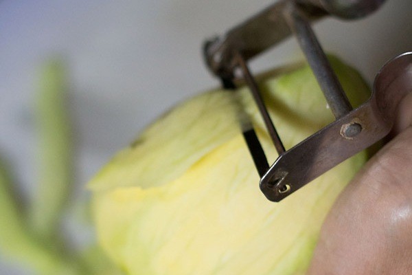 peeling raw mangoes to make amchur powder. 