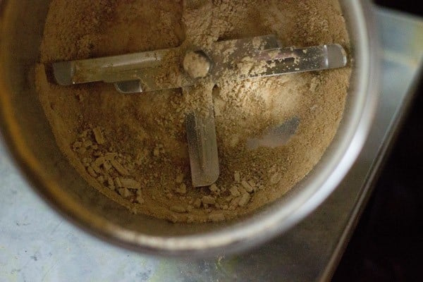 grinding mango pieces - making amchur powder