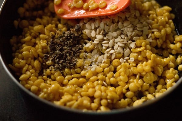 melon seeds, cardamom powder, black cardamom seeds and edible camphor added to sugar soaked boondi