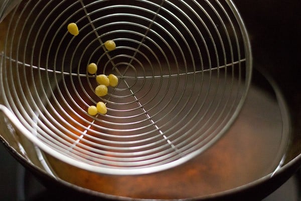 fried boondi in a spider spoon