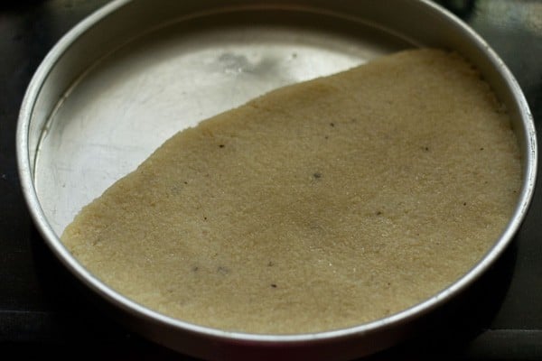 coconut barfi mixture pressed into a pan