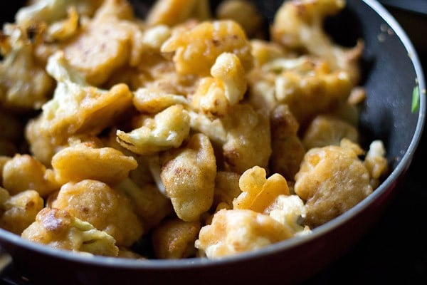 stir fry and fried gobi florets in a pan