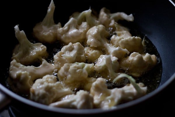 gobi in batter frying in a pan