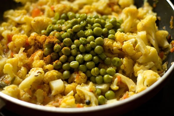 cooked green peas and garam masala powder added to the pan. 