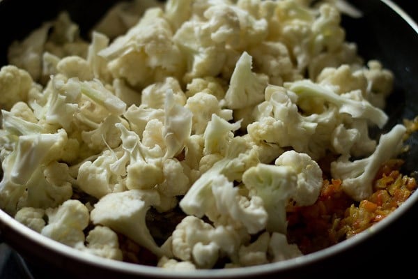 blanched cauliflower florets added to the pan. 