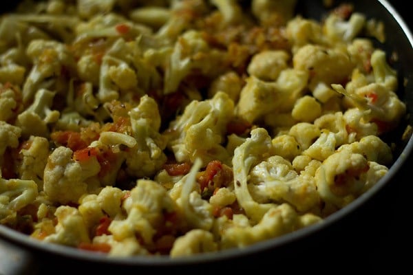 cauliflower florets mixed well with the onion-tomato mixture. 