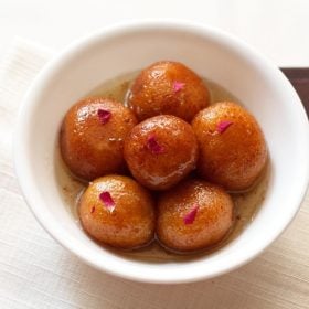 gulab jamun served in a white bowl