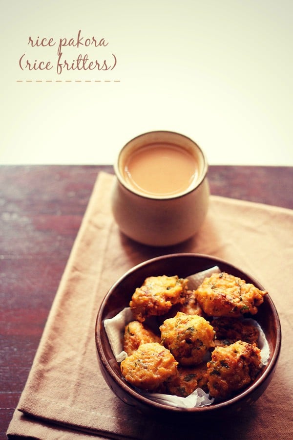 rice pakora served on a wooden plate with a mug of tea kept on top side and text layovers. 