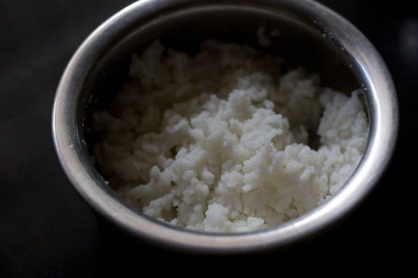 cooked rice added to a bowl. 