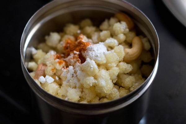 rock salt, powdered sugar and red chili powder added to fried ingredients for making sabudana chivda. 