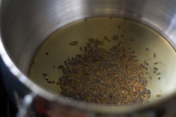 sautéing mustard seeds and cumin seeds in hot oil in pan. 