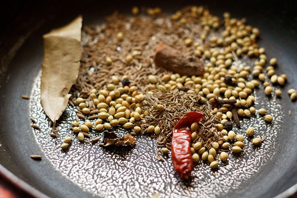 dry roasting spice in a pan for making goda masala. 