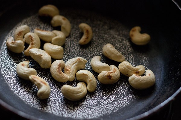 roasting cashews in a pan. 