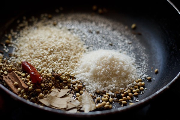 unsweetened desiccated coconut and white sesame seeds added to the pan. 