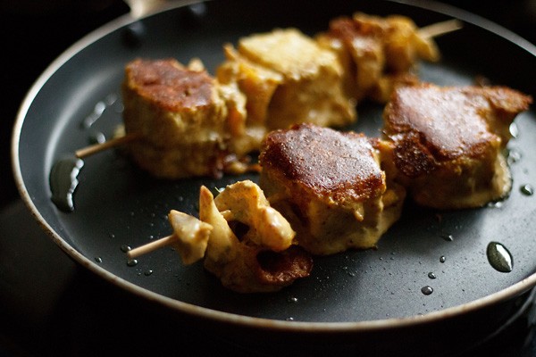 frying achari paneer tikka on stovetop