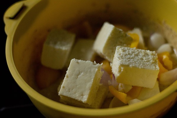 adding paneer capsicum onion to spiced curd