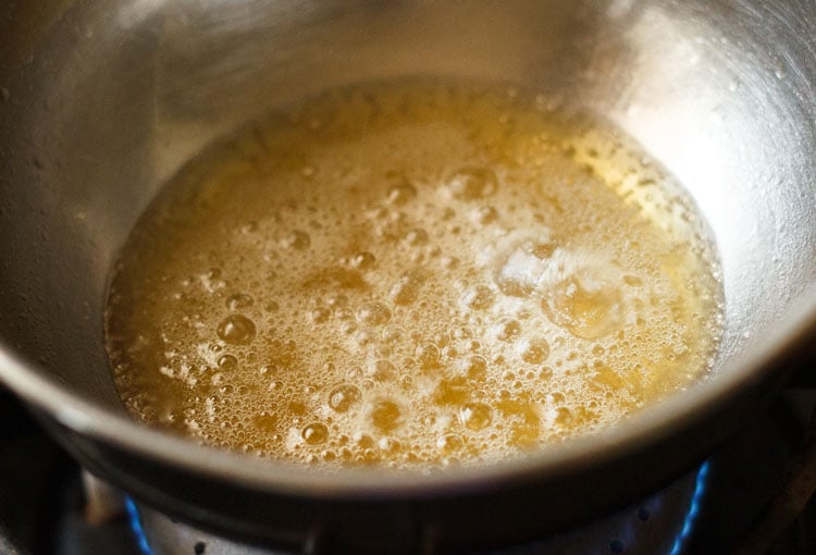 hot butter in steel bowl on the stove-top