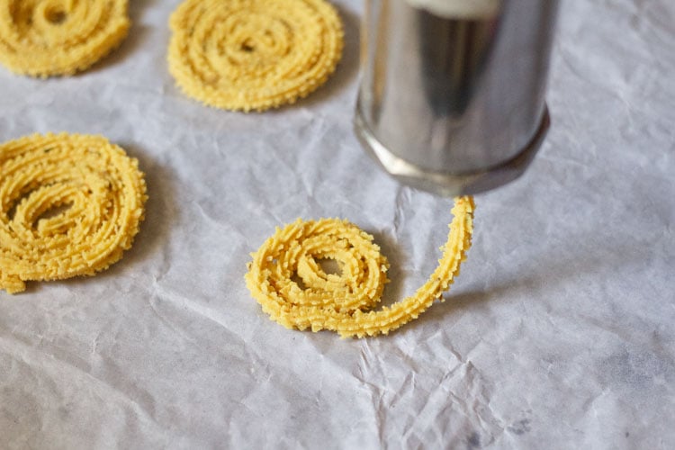 making circles from the dough with the chakli maker