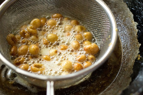 Fry the raisins until puffy. 