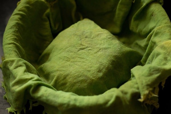dough covered with a bright green cotton napkin