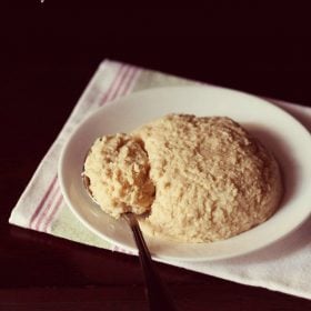 khoya in a white plate with a spoon on a white napkin with text layovers.