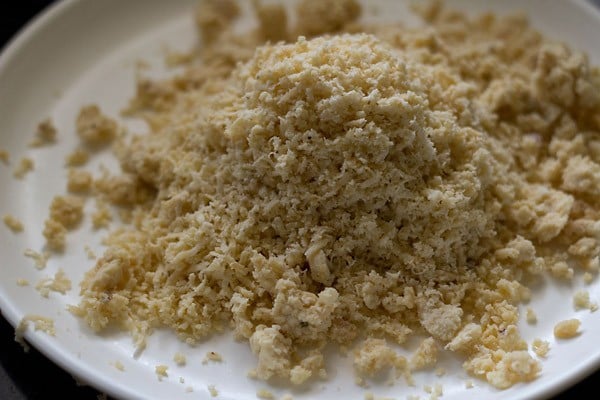 grated khoya on a plate for barfi recipe. 