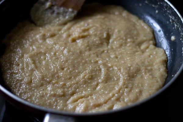 cooking sweetened khoya mixture as it starts becoming thick and leaving the sides of the pan. 